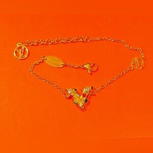 Louis Vuitton V Bracelet gold with multi color beads. Very nice piece. Adj size